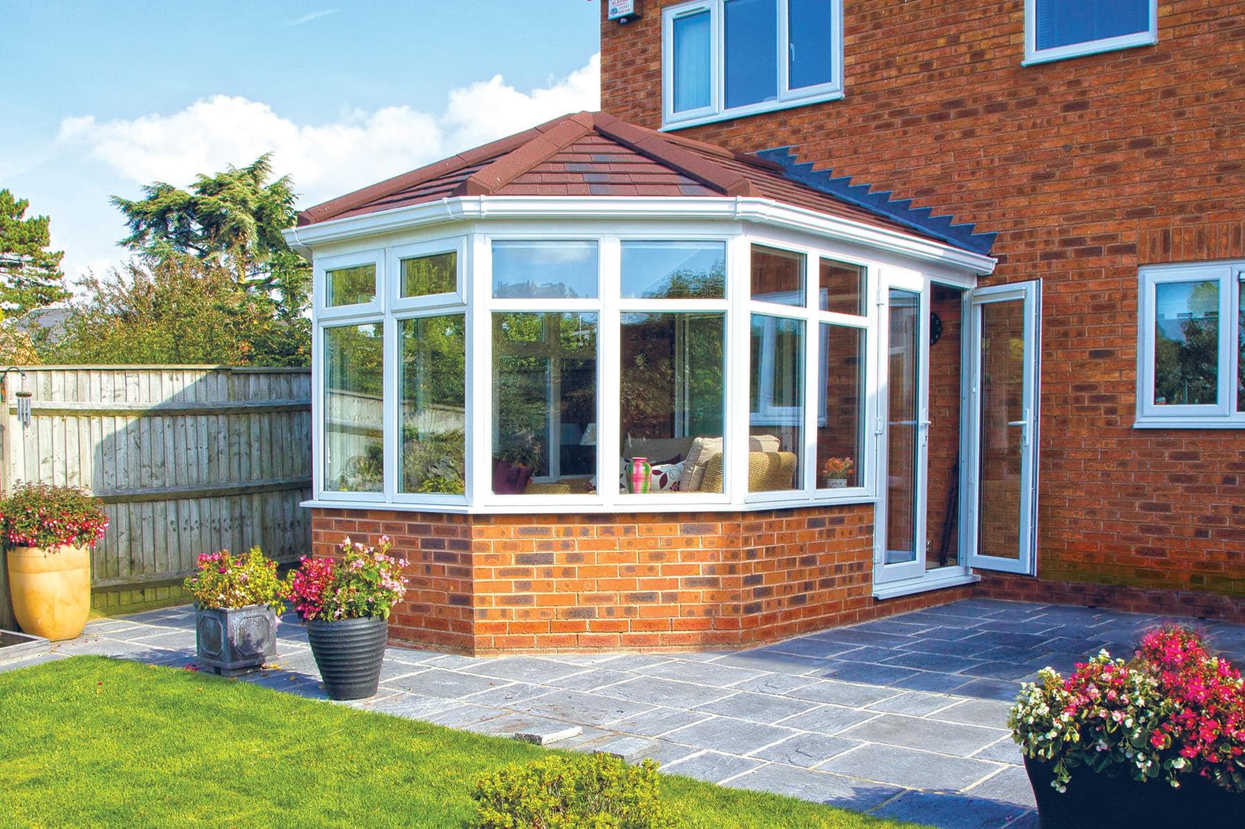 Conservatory in brick with white windows